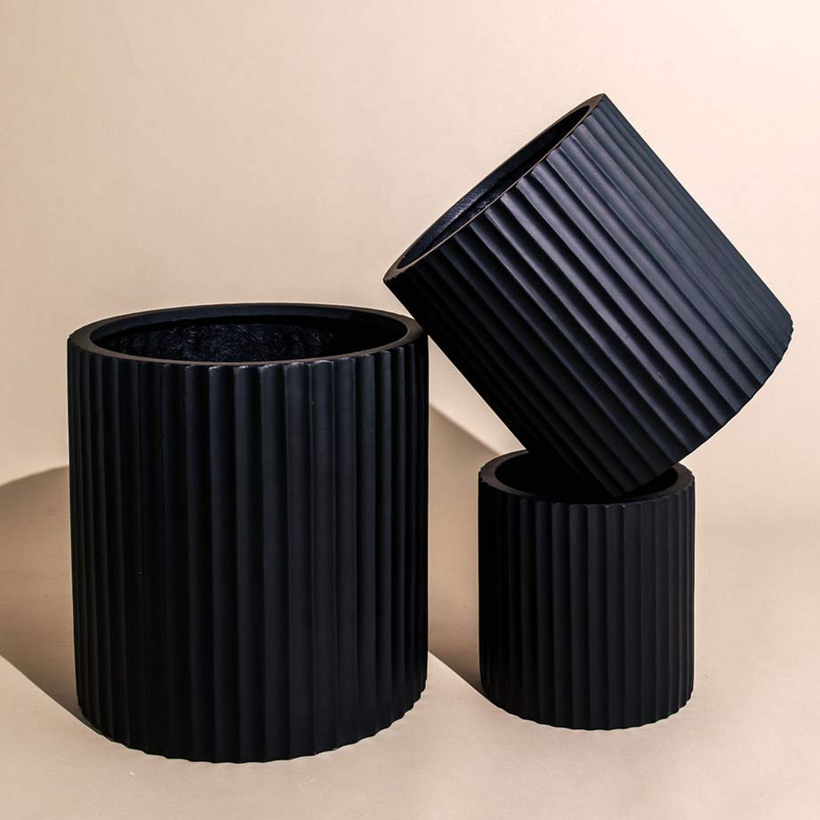 A cluster of three black ribbed textured Rosie pots in different sizes.