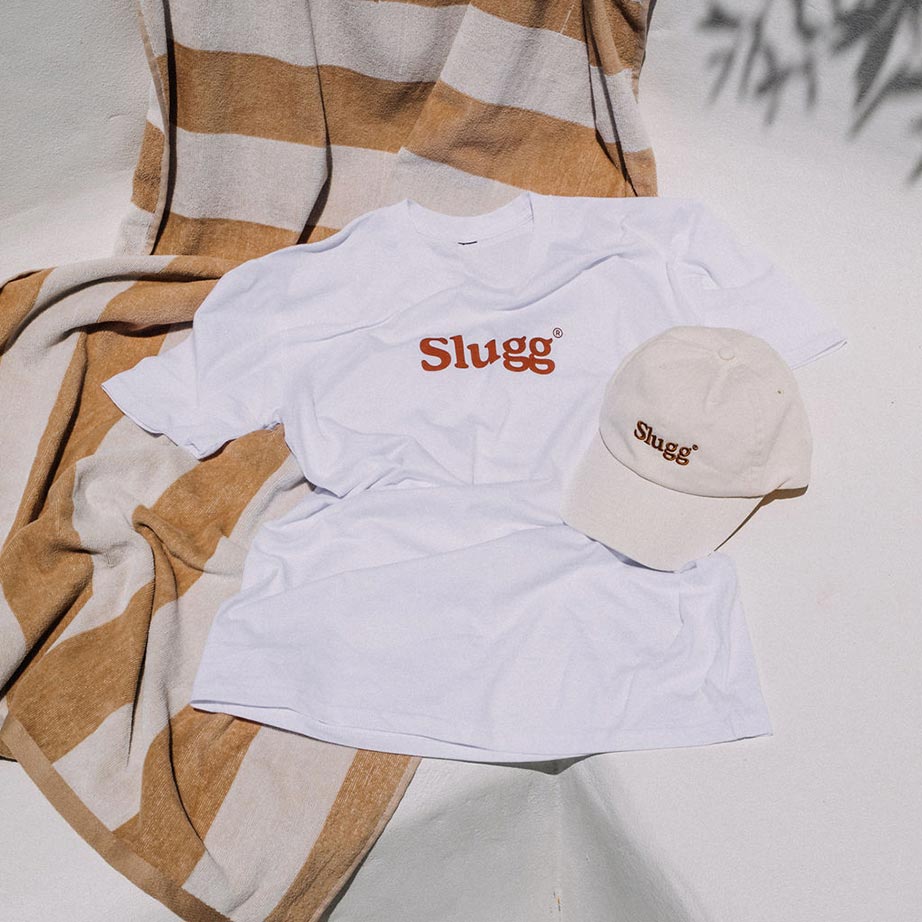 A Slugg branded white t-shirt and taupe colour cap.